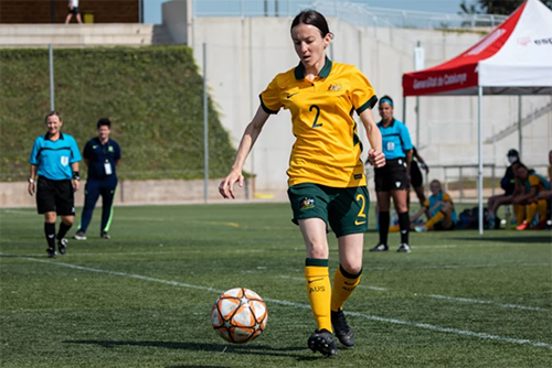 Nicole playing soccer