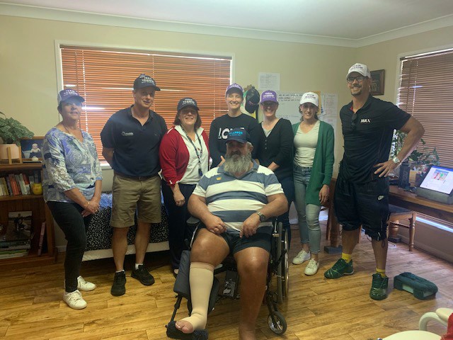 Clayton in his wheelchair posing with his family