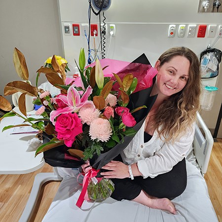 Karla with flowers when she was discharged from hospital