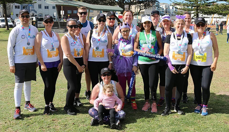People smiling and hugging at the end of a fun run
