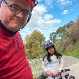 : Stuart Clegg and his daughter Asha Clegg from Sunshine on their bikes, wearing red tops