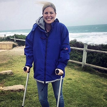 Rachael at the beach on crutches