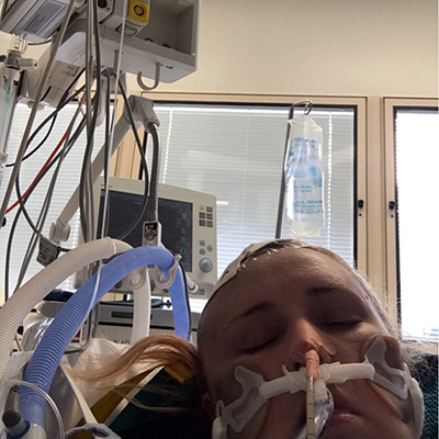 Heidi hooked up to wires in her hospital bed