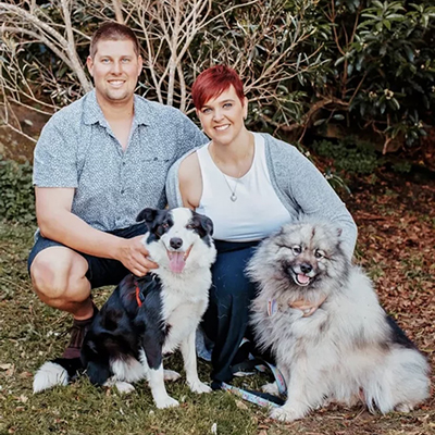 Stacey sitting with her boyfriend and dogs