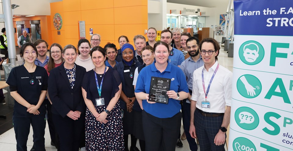 A group of health professionals pose with a certification