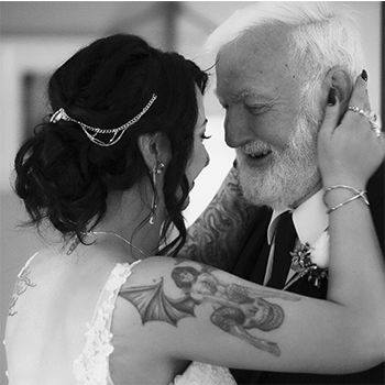Joanna hugging and smiling at her Dad at her wedding