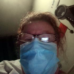 Debra with a face mask on in hospital