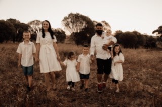 Adelynn outside with her family