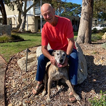 Peter playing outside with his dog