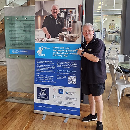 Chris next to a poster of the UPLIFT trial