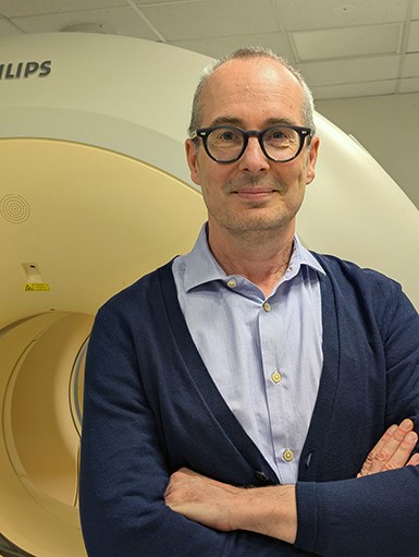 Professor Vincent Thijs at the Alfred Hospital in front of a PET scan